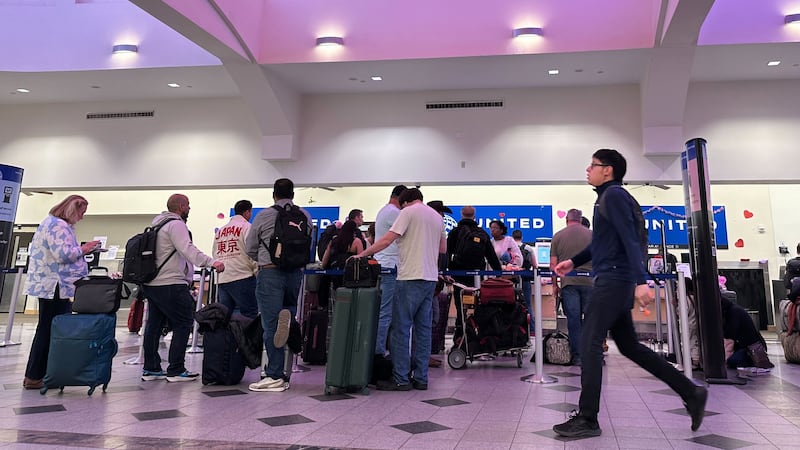 People stand in line at check-in counters at El Paso International Airport, Wednesday, Feb....